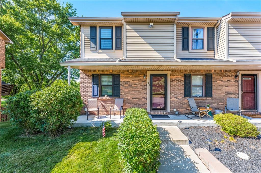a front view of a house with garden and porch