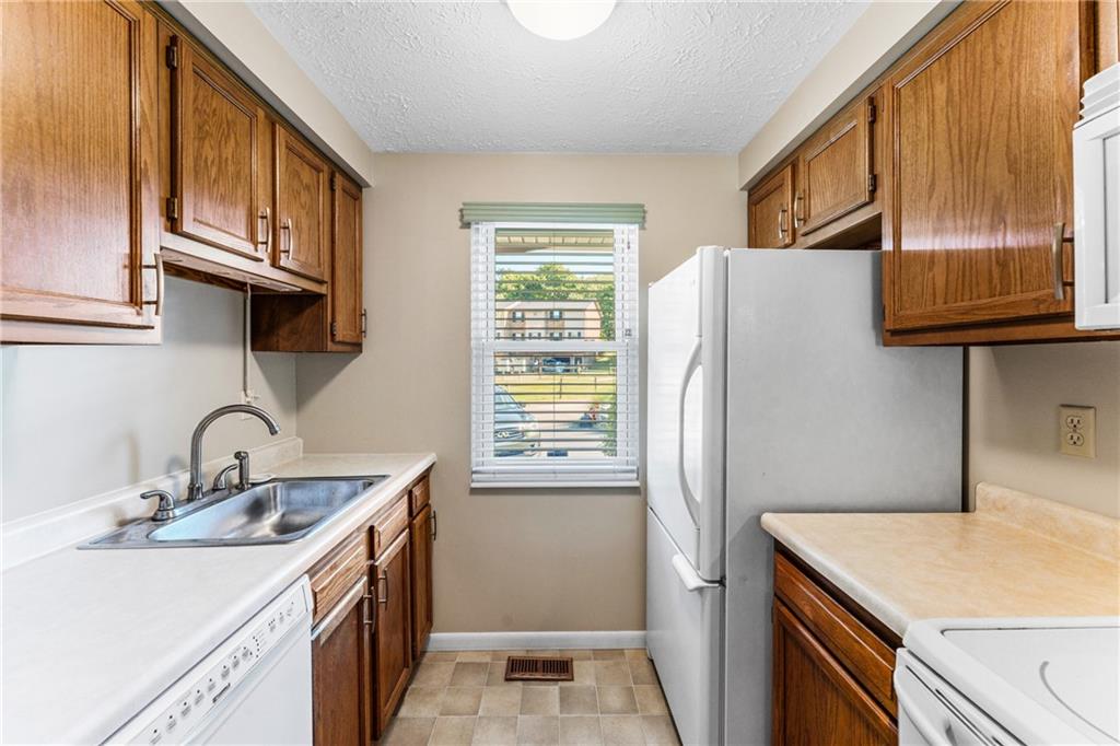 113 Forest Drive Seven Fields, PA 16046 - Photo 12 of 32 a kitchen with stainless steel appliances granite countertop a refrigerator and a sink