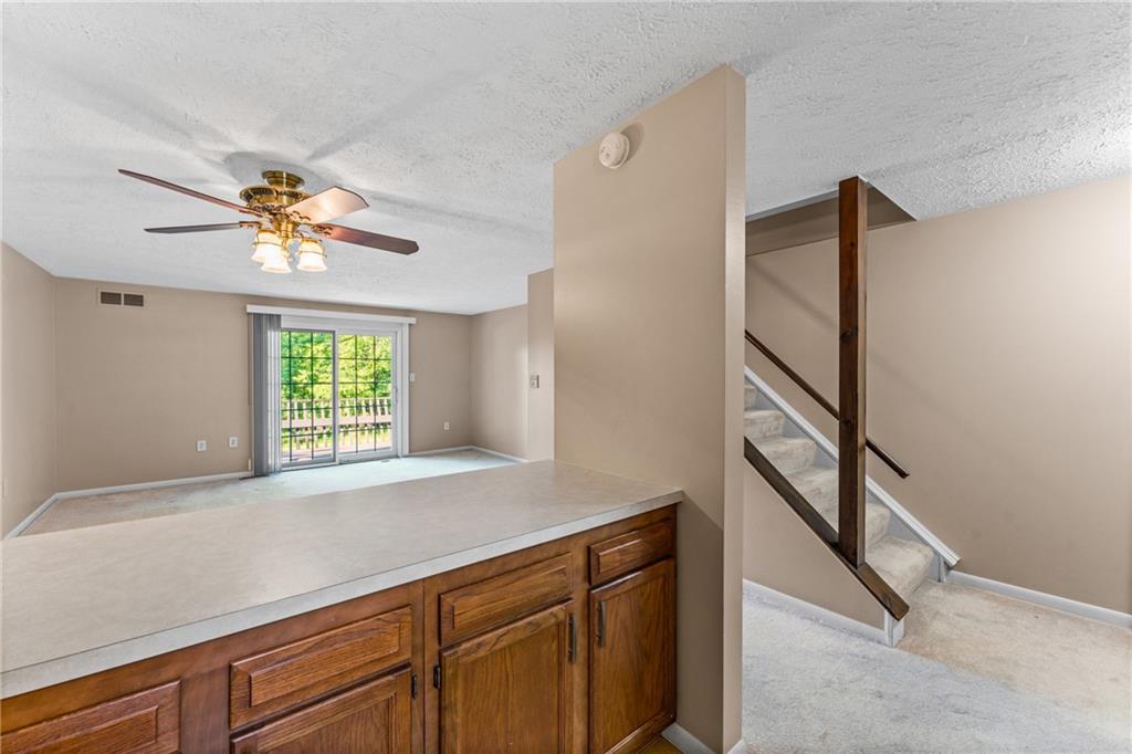 113 Forest Drive Seven Fields, PA 16046 - Photo 14 of 32 a kitchen with a refrigerator and a chandelier