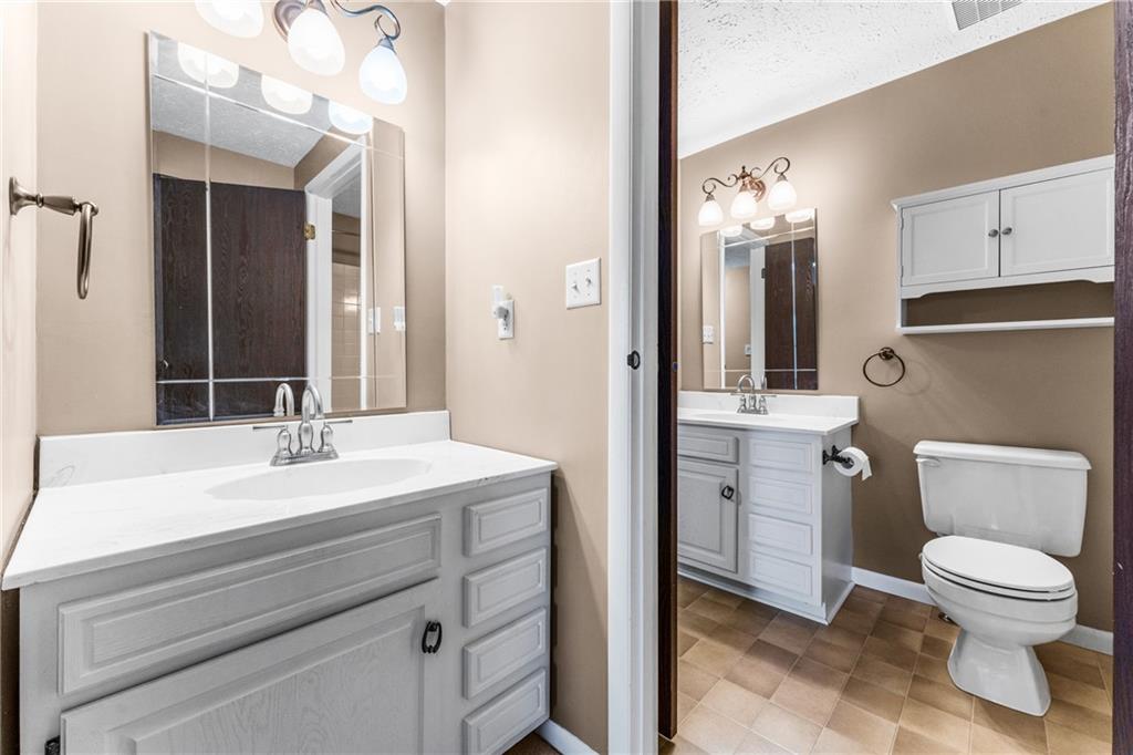 113 Forest Drive Seven Fields, PA 16046 - Photo 18 of 32 a bathroom with a sink a toilet and a mirror