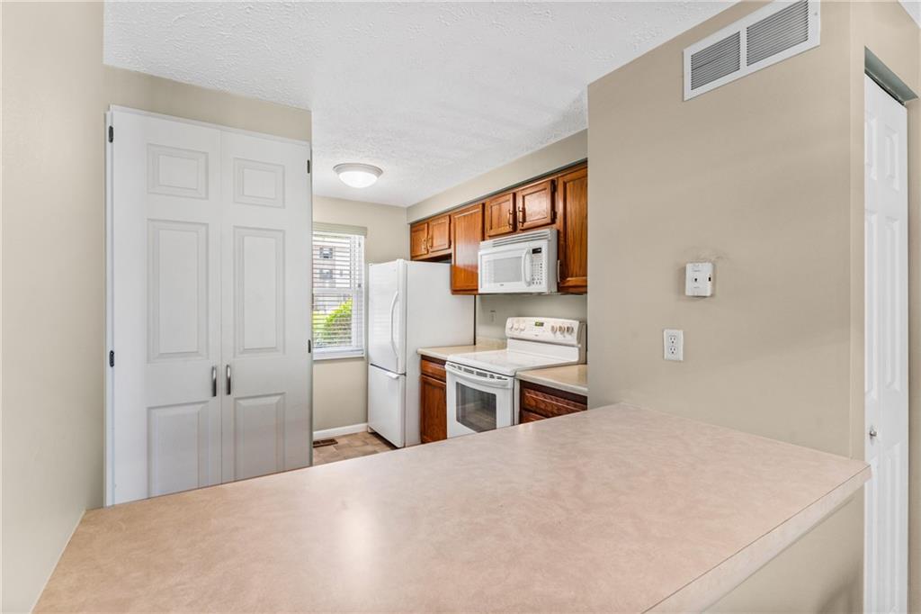 113 Forest Drive Seven Fields, PA 16046 - Photo 10 of 32 a kitchen with a refrigerator and a sink