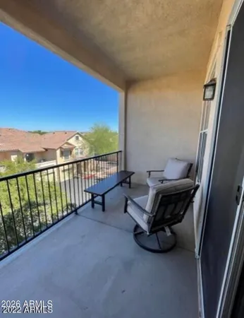 a view of a porch with furniture and floor to ceiling window