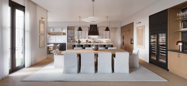 a large white kitchen with stainless steel appliances kitchen island granite countertop a dining table and chairs