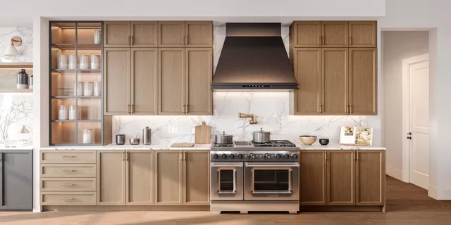 a kitchen with kitchen island granite countertop a sink cabinets and stainless steel appliances