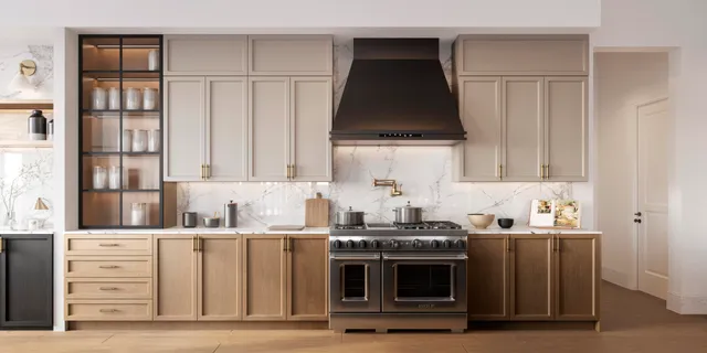 a kitchen with stainless steel appliances a stove a sink and white cabinets