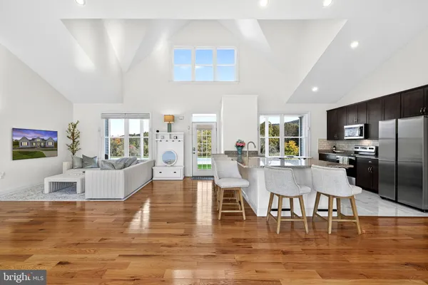 a living room with fireplace furniture and a wooden floor