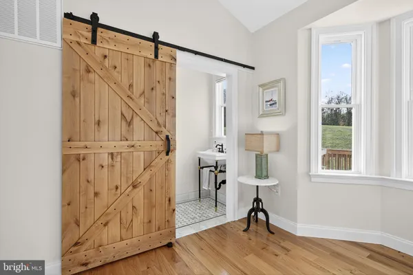 a view of entryway with wooden floor and stairs