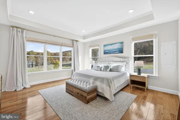 a bedroom with a large bed couch and a window