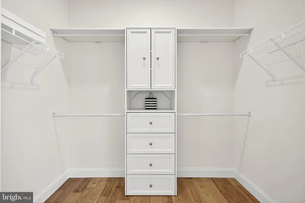 a view of walk in closet with cabinet