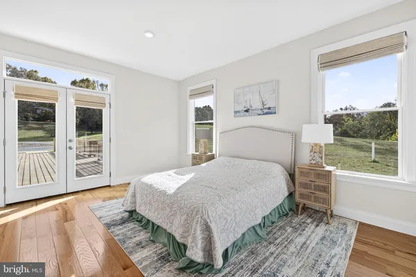 a bedroom with a large bed and a window