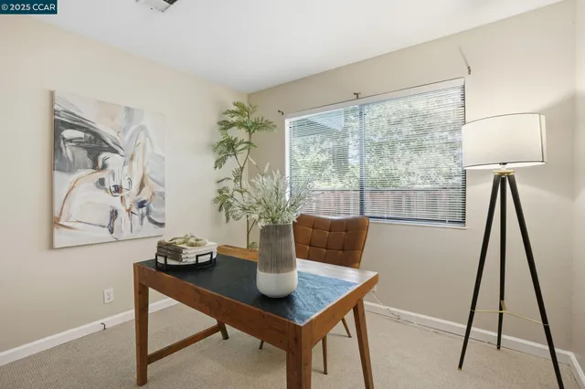 a living room with a couch and a floor to ceiling window