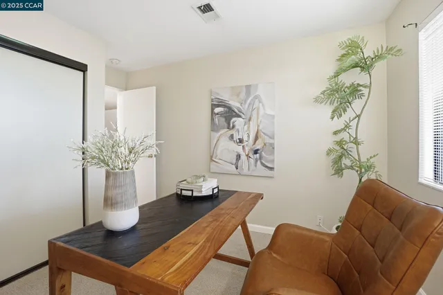 a living room with furniture and flowers