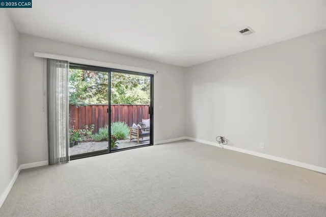a view of a room with wooden floor and a sliding door