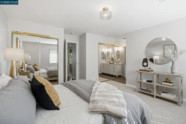 a large bedroom with bed and a chandelier