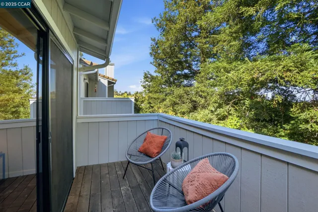 a backyard of a house with a table and chairs