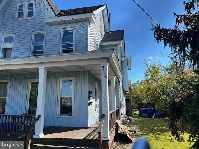 a view of a house with a yard balcony and tree s