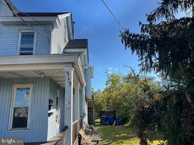 a view of a small space with wooden floor and a window