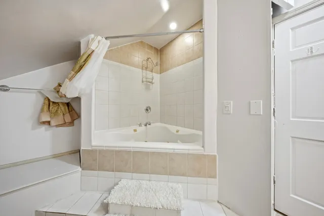 a bathroom with a bathtub and a shower
