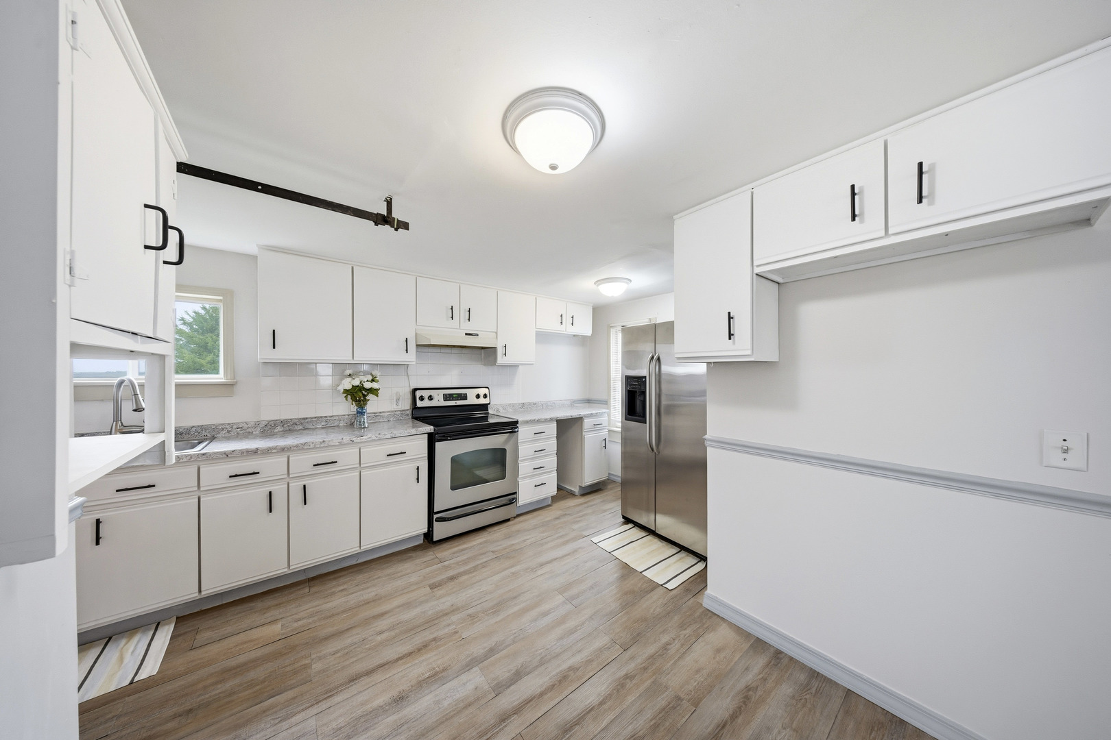 901 Hermann Road Lee, IL 60530 - Photo 22 of 42 a kitchen with granite countertop a refrigerator stove top oven and sink