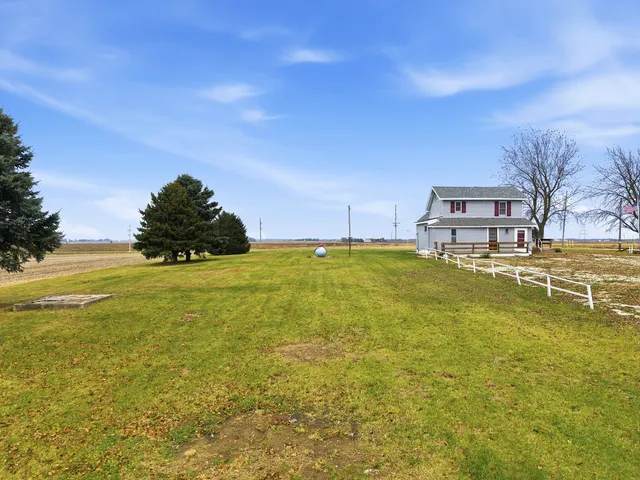 a view of house with backyard and garden