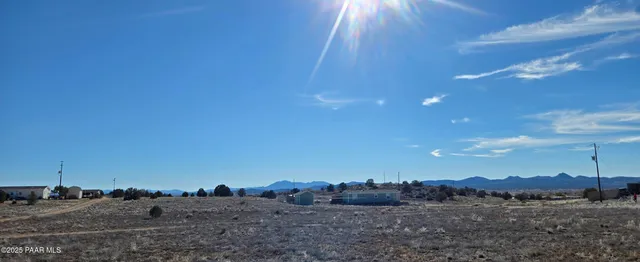 a view of ocean and middle of a field