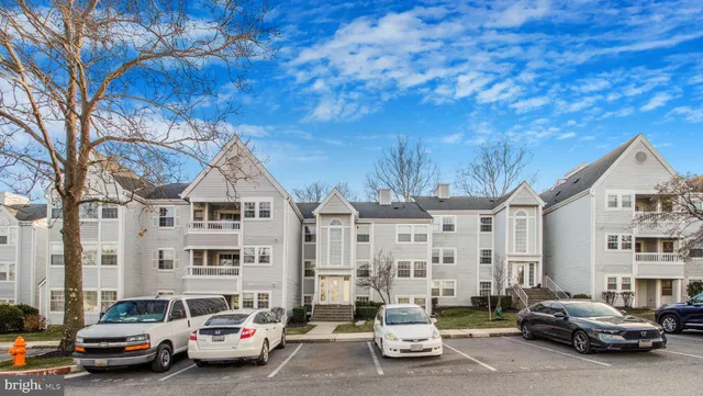 a city street lined with parked cars and buildings
