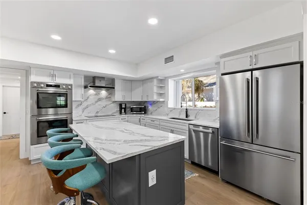 a room with pool table and windows
