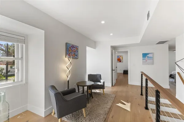 a living room with furniture and a floor to ceiling window