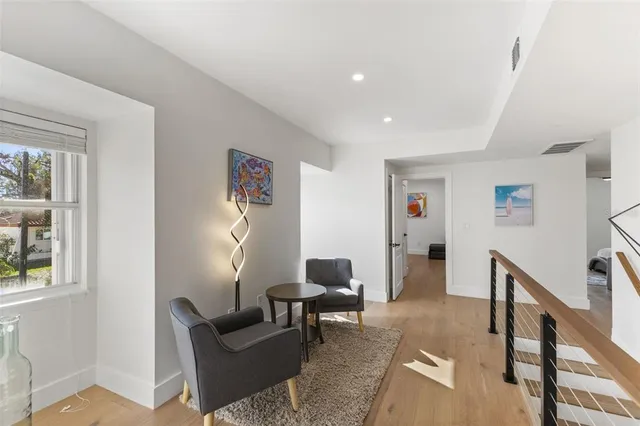 a living room with furniture and a floor to ceiling window