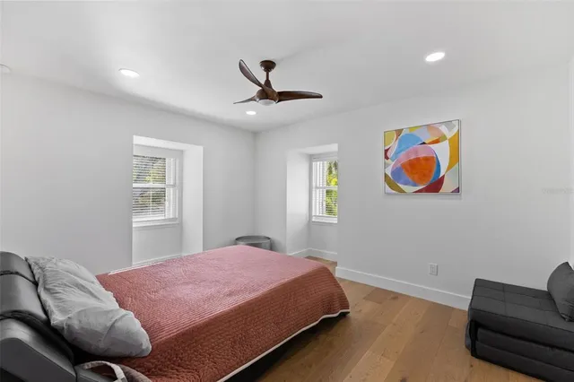 a view of backyard with table and chairs and potted plants