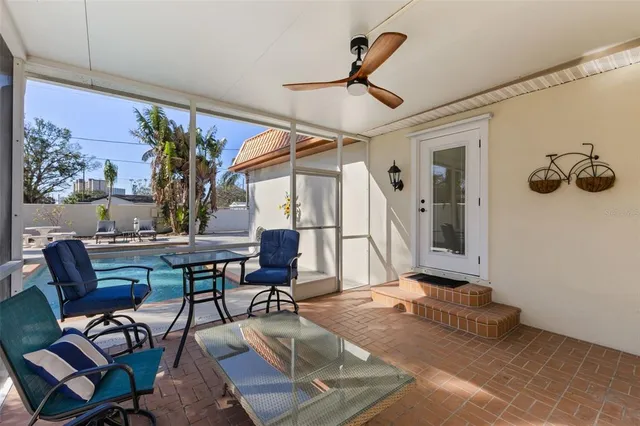a front view of a house with a yard and potted plants