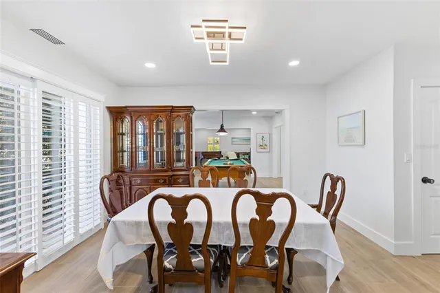 a living room with furniture a piano and a window