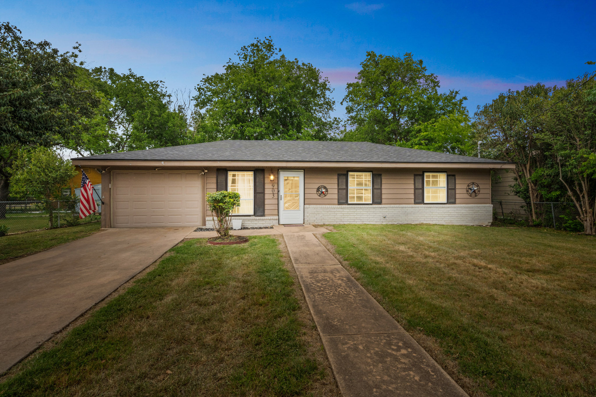 903 West 18th Street Georgetown, TX 78626 - Photo 1 of 1 Ranch-style house featuring driveway, brick siding, fence, a yard, and an attached garage