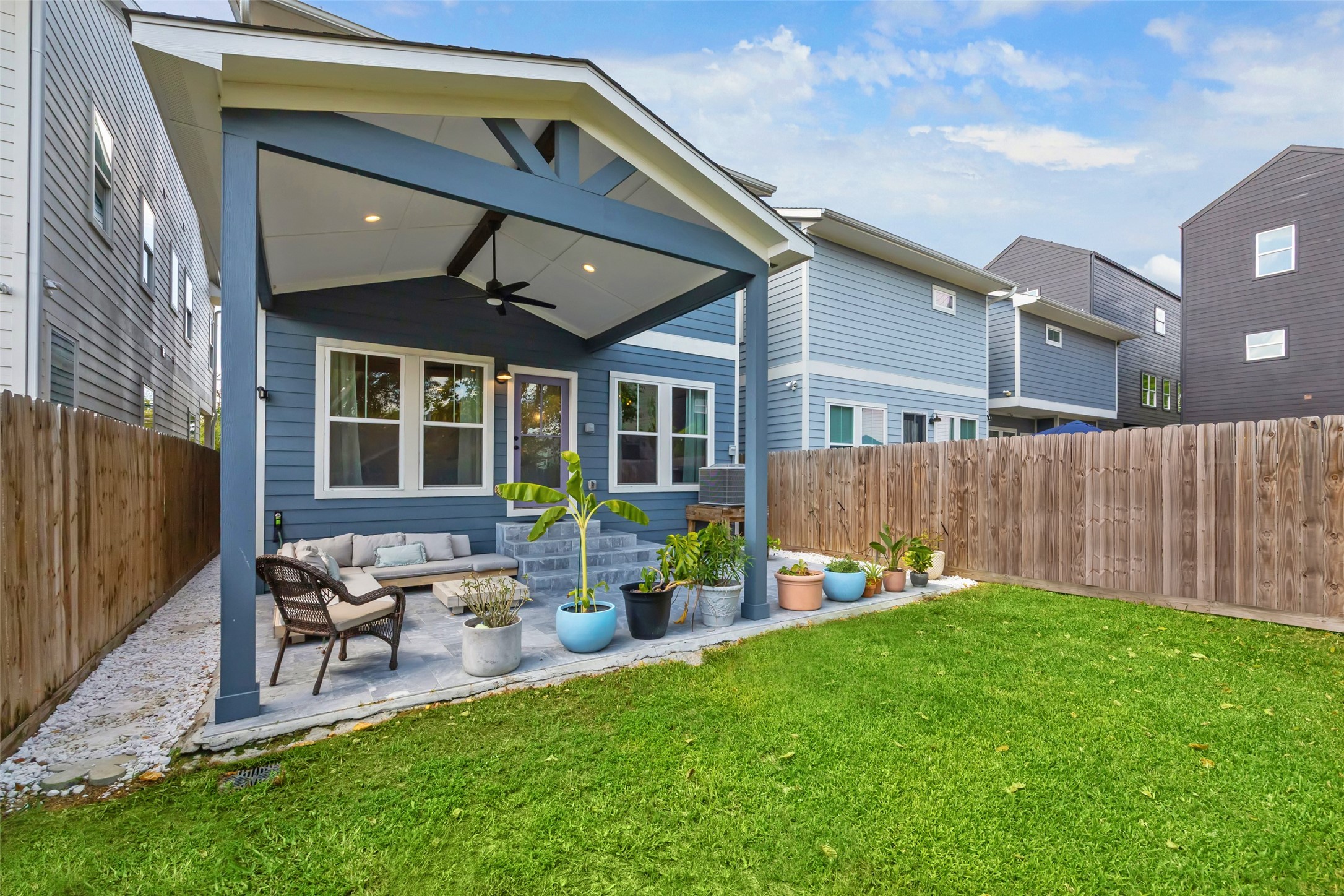 a front view of a house with garden and patio