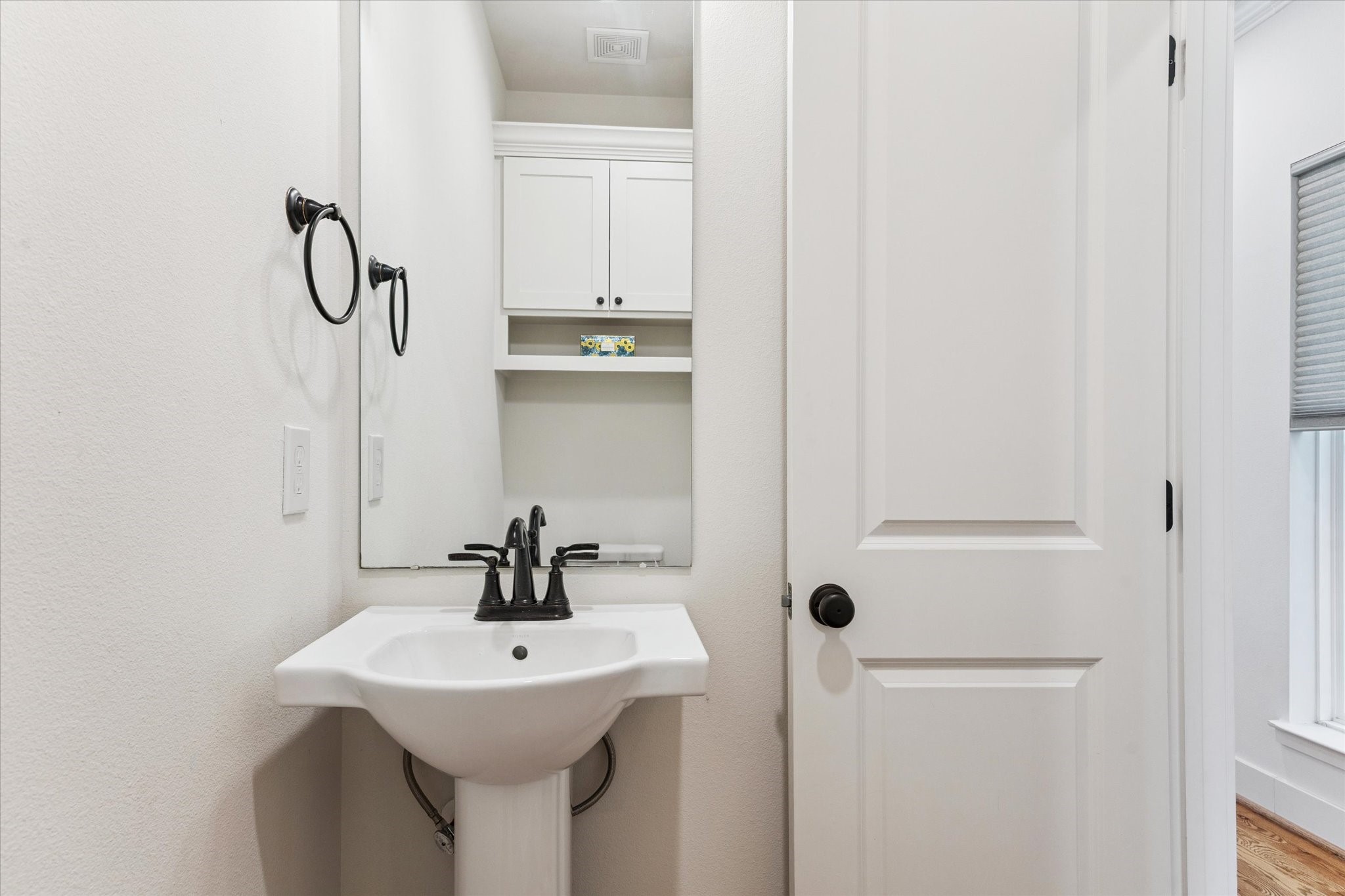 3404 Castor Street Houston, TX 77022 - Photo 12 of 30 a bathroom with a sink and mirror