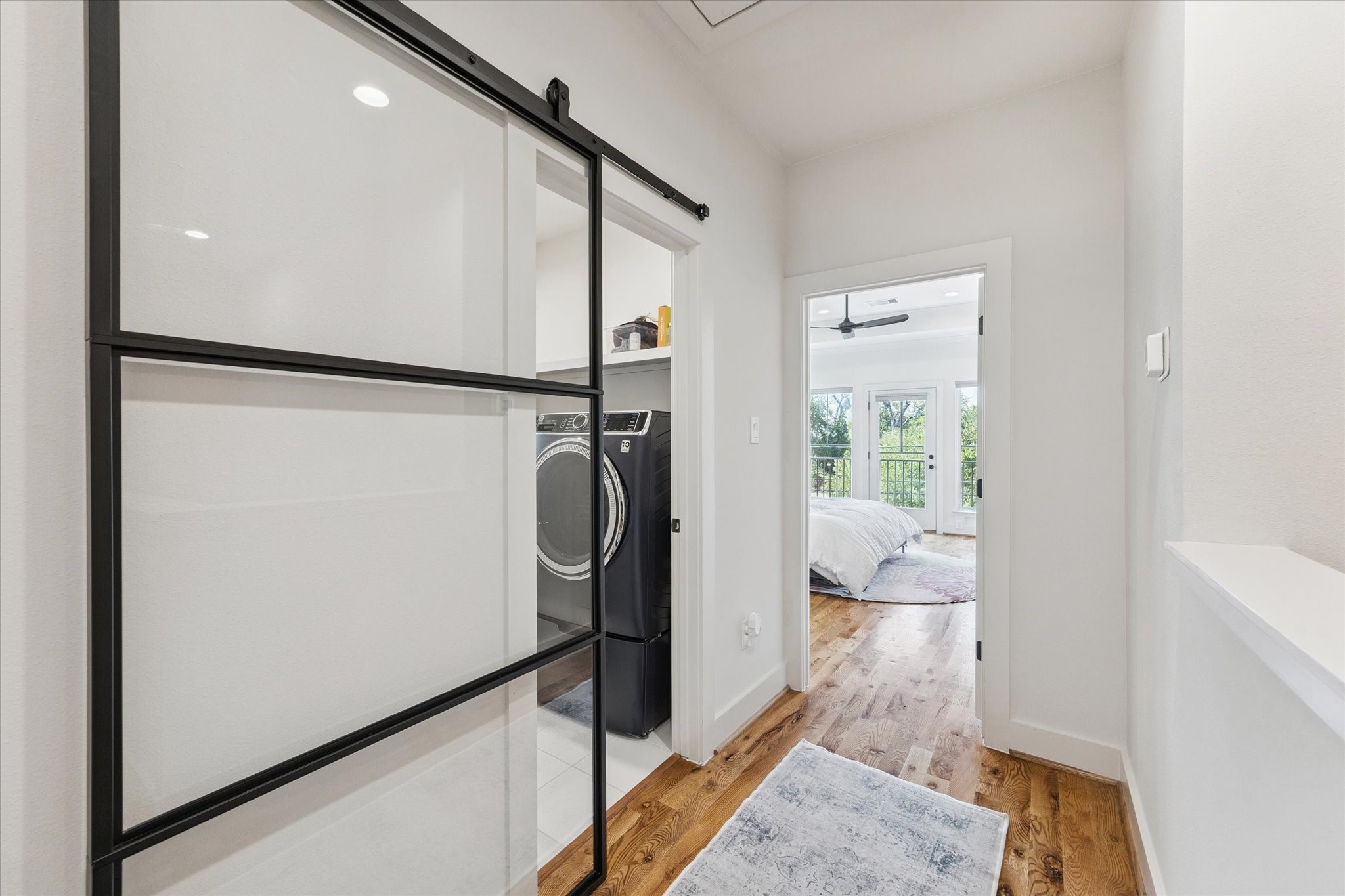 3404 Castor Street Houston, TX 77022 - Photo 13 of 30 a walk in closet with wooden floor and a bathroom