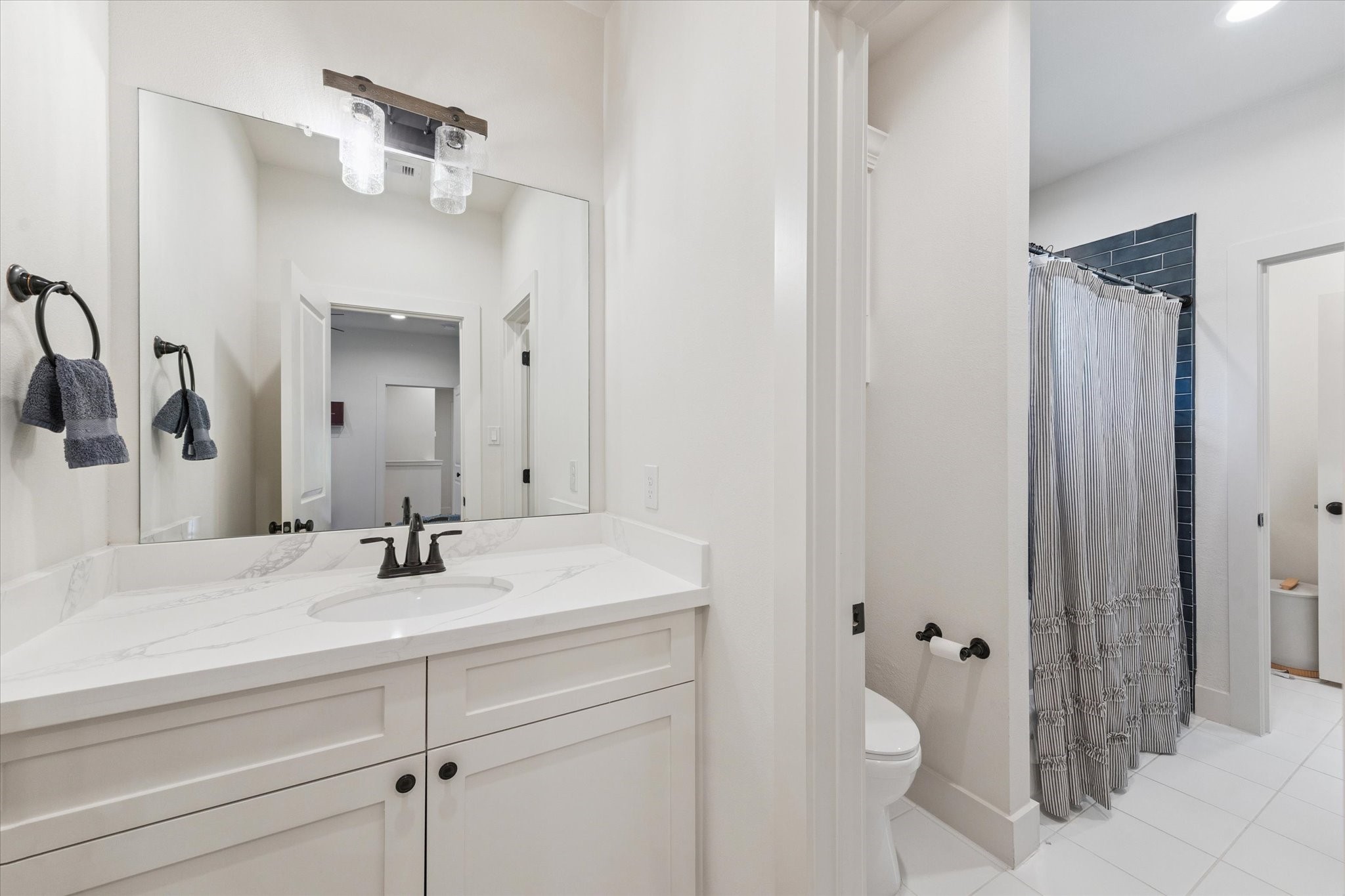 3404 Castor Street Houston, TX 77022 - Photo 23 of 30 a bathroom with a sink and a mirror