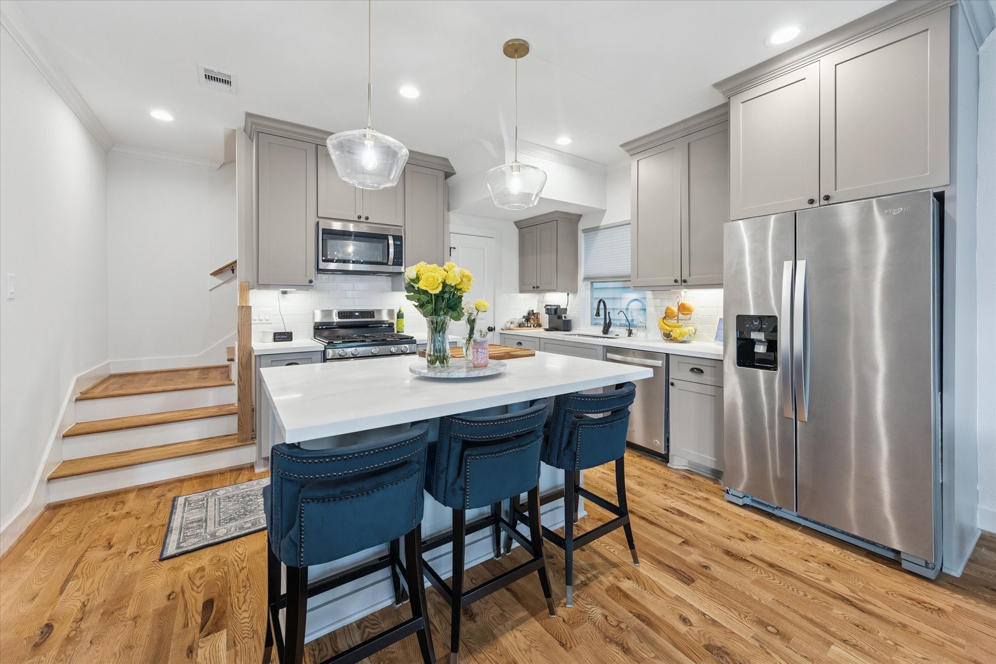 3404 Castor Street Houston, TX 77022 - Photo 9 of 30 a kitchen with a table chairs refrigerator and microwave