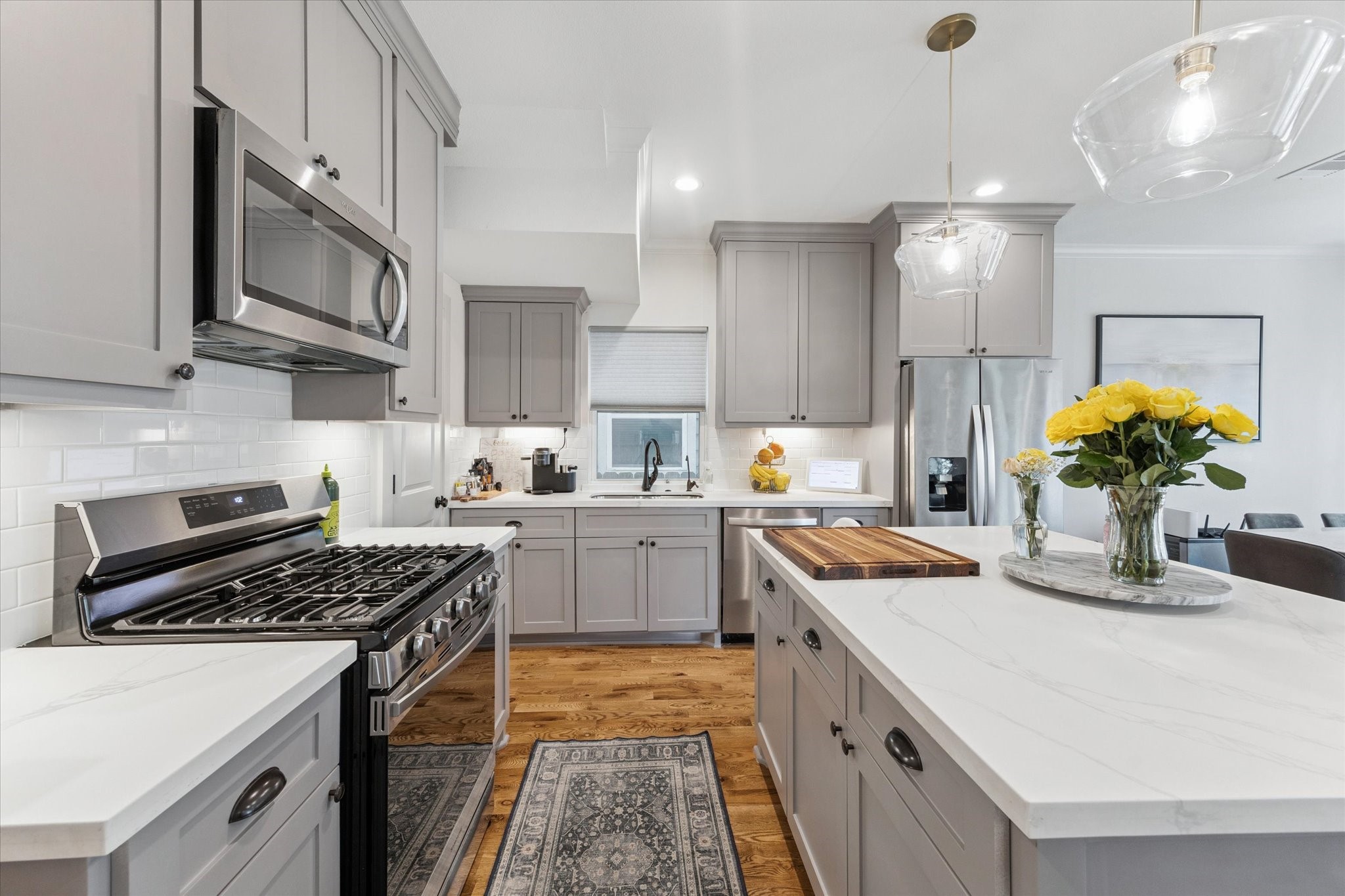 3404 Castor Street Houston, TX 77022 - Photo 10 of 30 a kitchen with stainless steel appliances a sink a stove top oven a counter space and cabinets