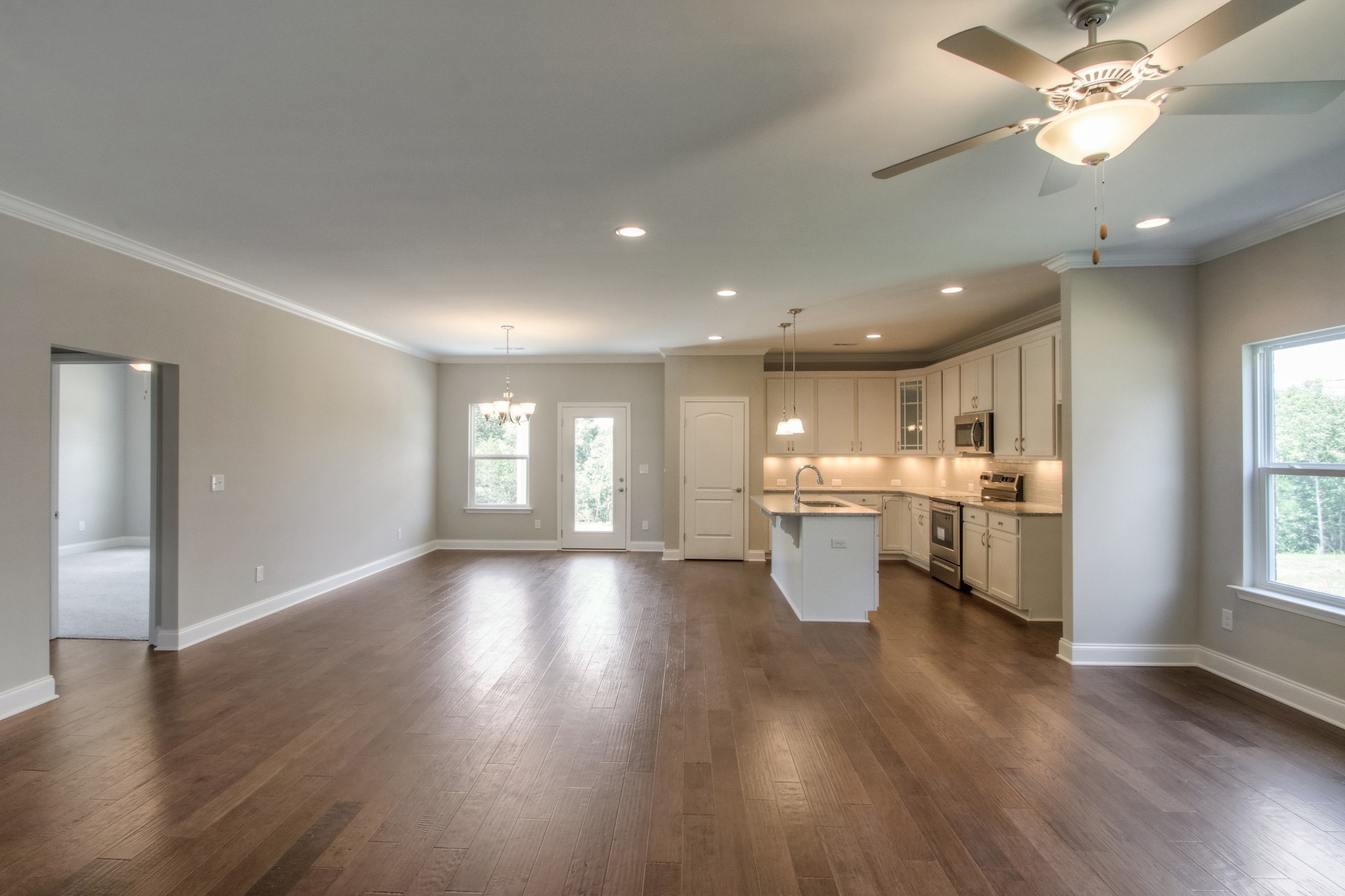 1529 Holton Road Gallatin, TN 37066 - Photo 11 of 33 a view of an empty room and kitchen with wooden floor