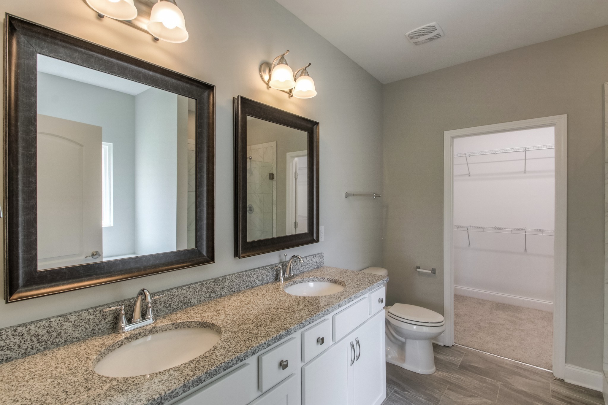 1529 Holton Road Gallatin, TN 37066 - Photo 19 of 33 a bathroom with a granite countertop sink toilet a mirror and a shower
