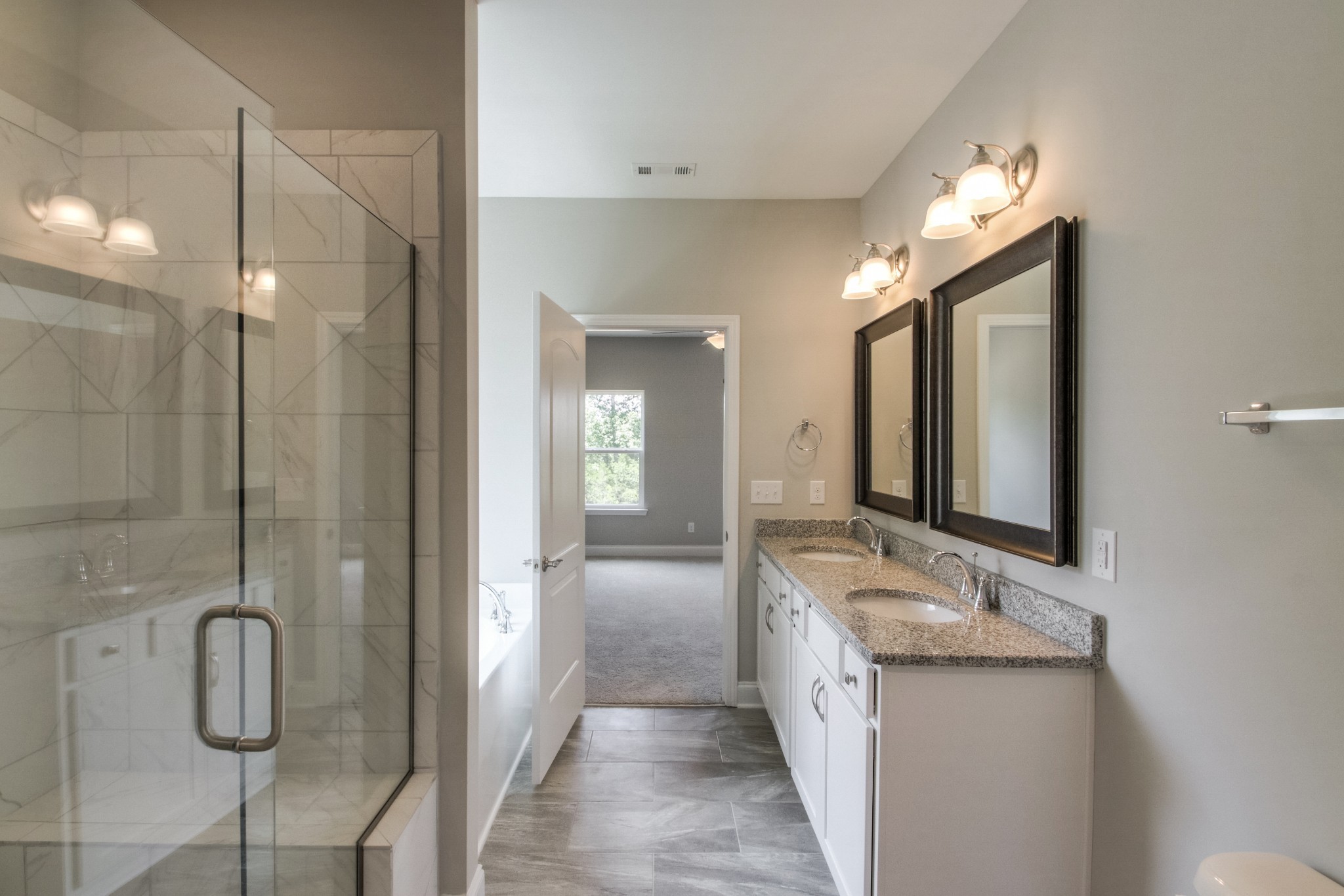 1529 Holton Road Gallatin, TN 37066 - Photo 23 of 33 a bathroom with a double vanity sink a mirror and a shower