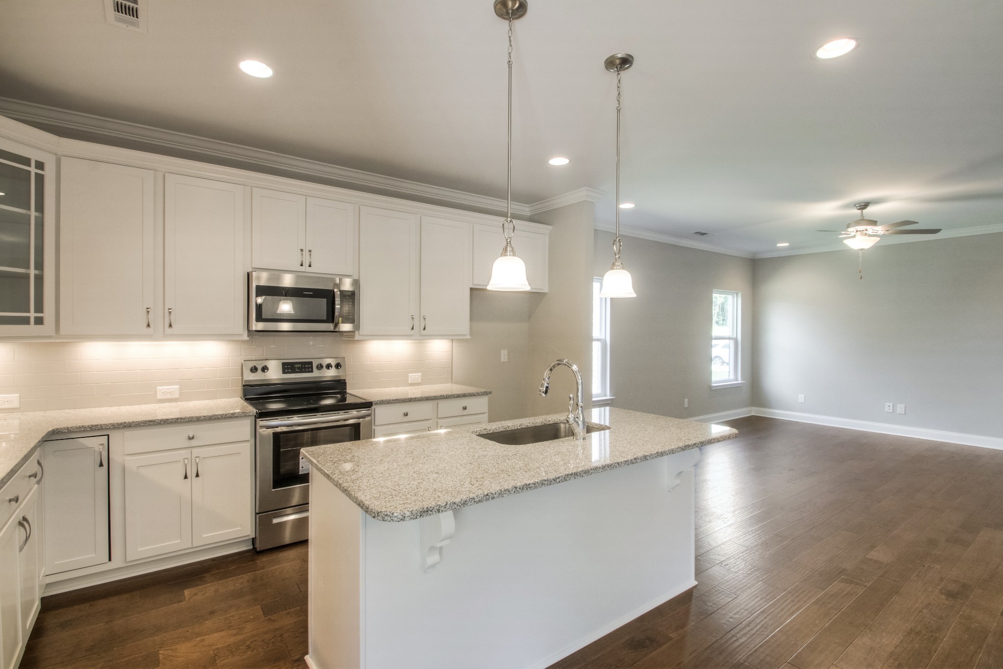 1529 Holton Road Gallatin, TN 37066 - Photo 8 of 33 a kitchen with stainless steel appliances granite countertop a sink a stove and a wooden floors