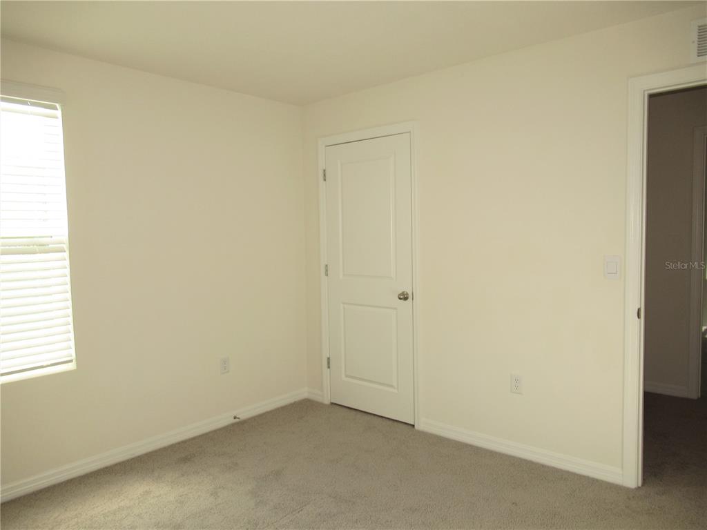 12178 Lily Magnolia Lane Riverview, FL 33569 - Photo 22 of 23 an empty room with windows