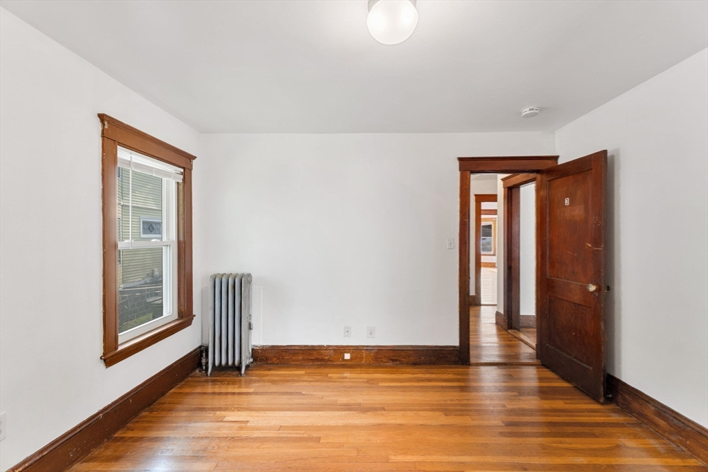 25 Tip Top Street, Unit 2 Boston, MA 02135 - Photo 15 of 35 a view of empty room with wooden floor and fan