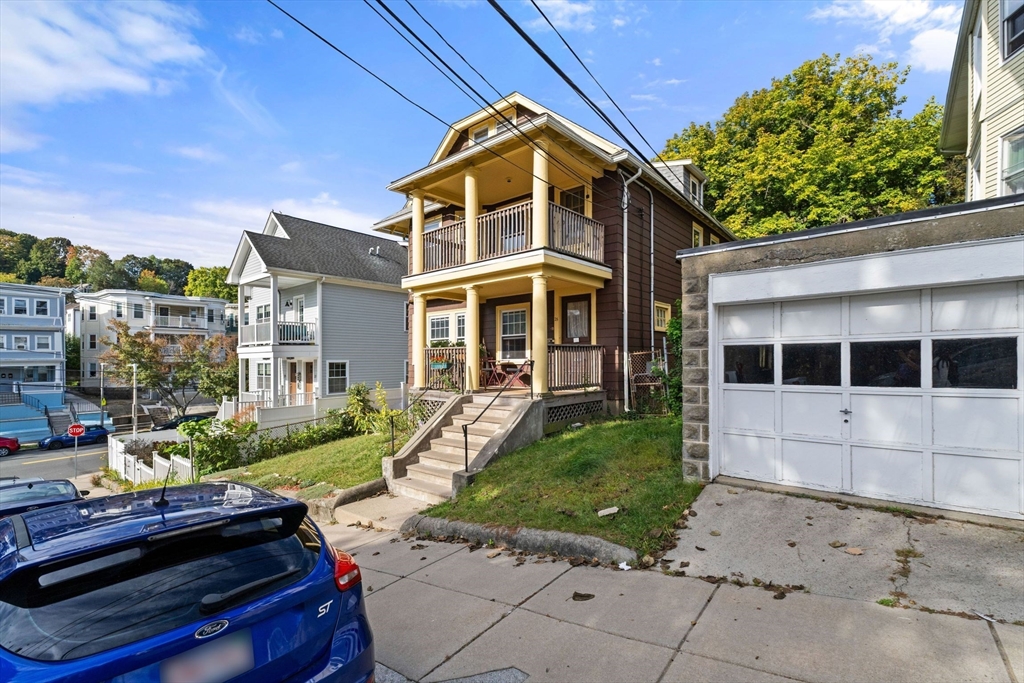 25 Tip Top Street, Unit 2 Boston, MA 02135 - Photo 2 of 35 a front view of a house with a yard
