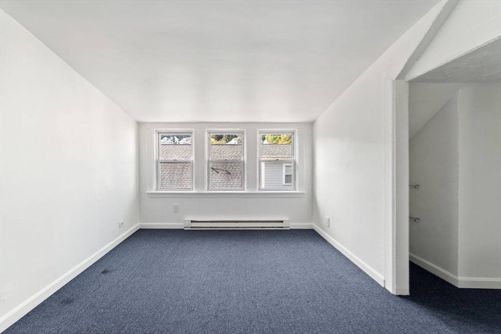 25 Tip Top Street, Unit 2 Boston, MA 02135 - Photo 27 of 35 an empty room with windows