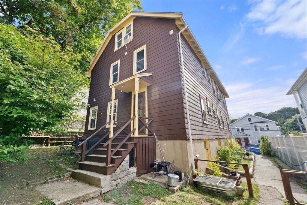 25 Tip Top Street, Unit 2 Boston, MA 02135 - Photo 35 of 35 a front view of a house with a yard