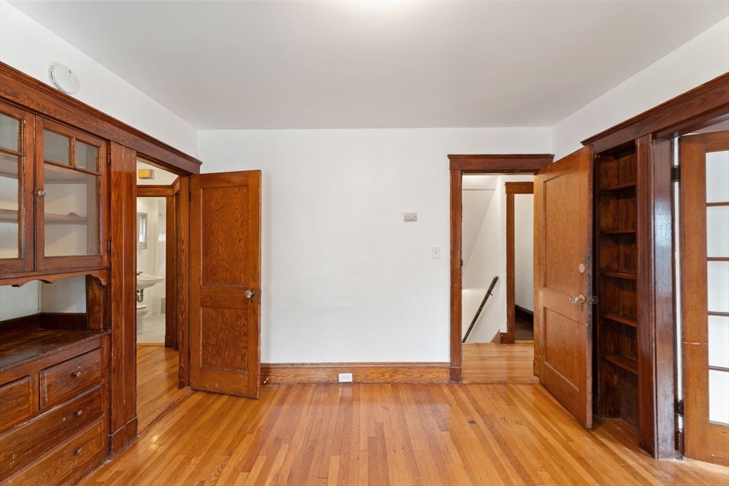 25 Tip Top Street, Unit 2 Boston, MA 02135 - Photo 10 of 35 a view of empty room with wooden floor and fan