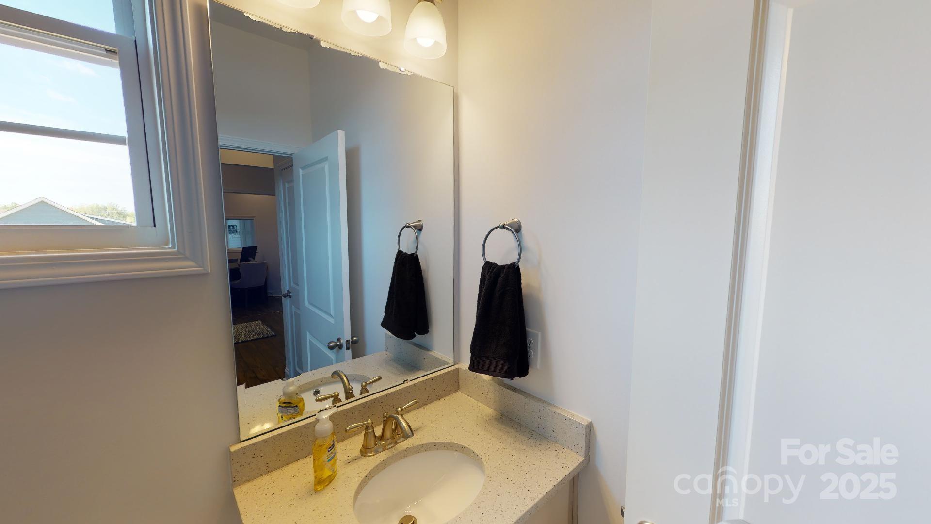 7653 Bainbridge Road Sherrills Ford, NC 28673 - Photo 5 of 25 a bathroom with a sink and mirror with bathtub